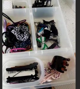 girls hair accessories organized in a plastic container