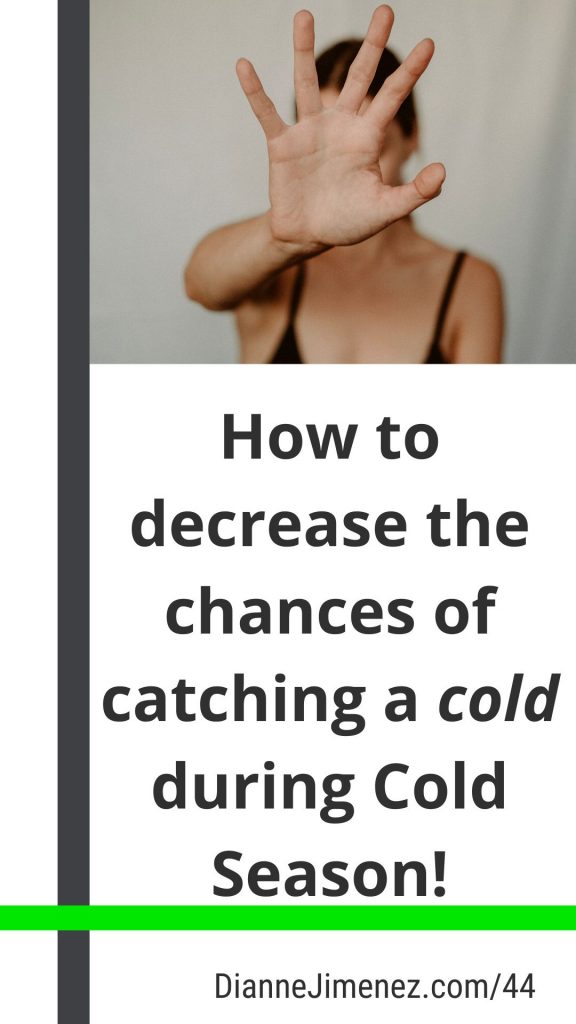 Image of a woman with her hand up signaling "stop" to "catching" a cold during Cold Season