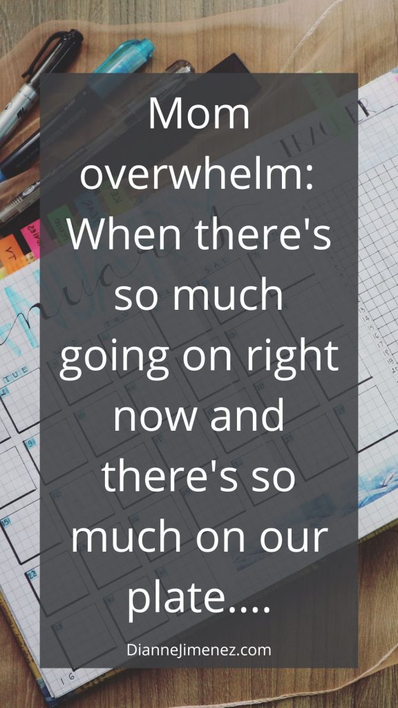 "Mom overwhelm" definition in the foreground and the background image is that of a daily planner, pens, markers and colorful tabs to show that this is part of navigating mom overwhelm