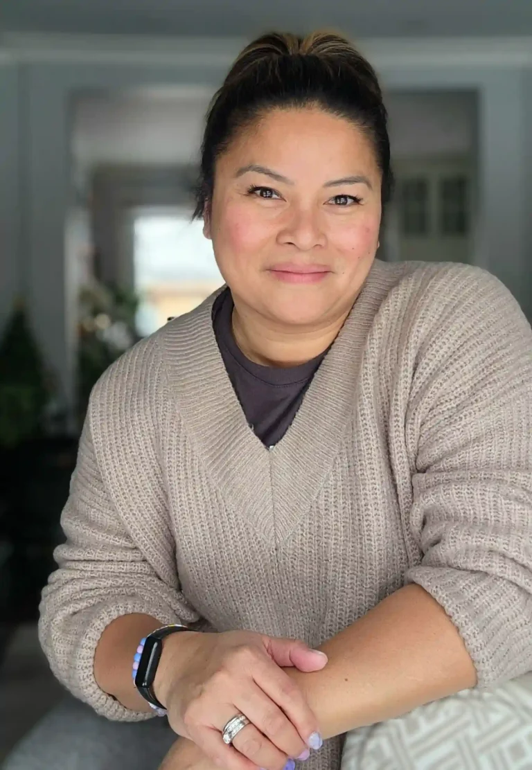 Dianne Jimenez posing mid frame with hands crossed smiling ,wearing a beige-brown textured sweater